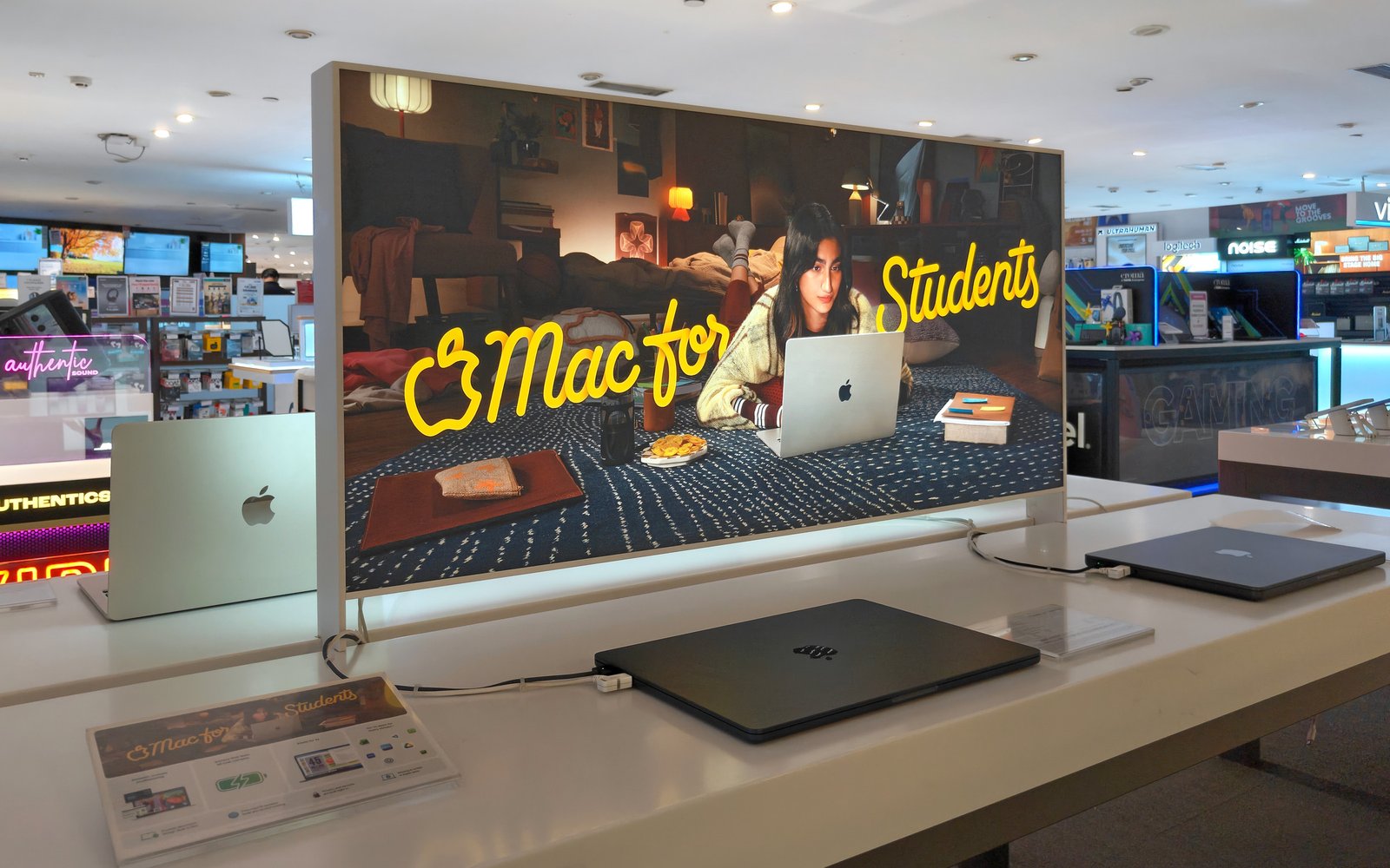 Mac for Students 2026 display above a MacBook retail table